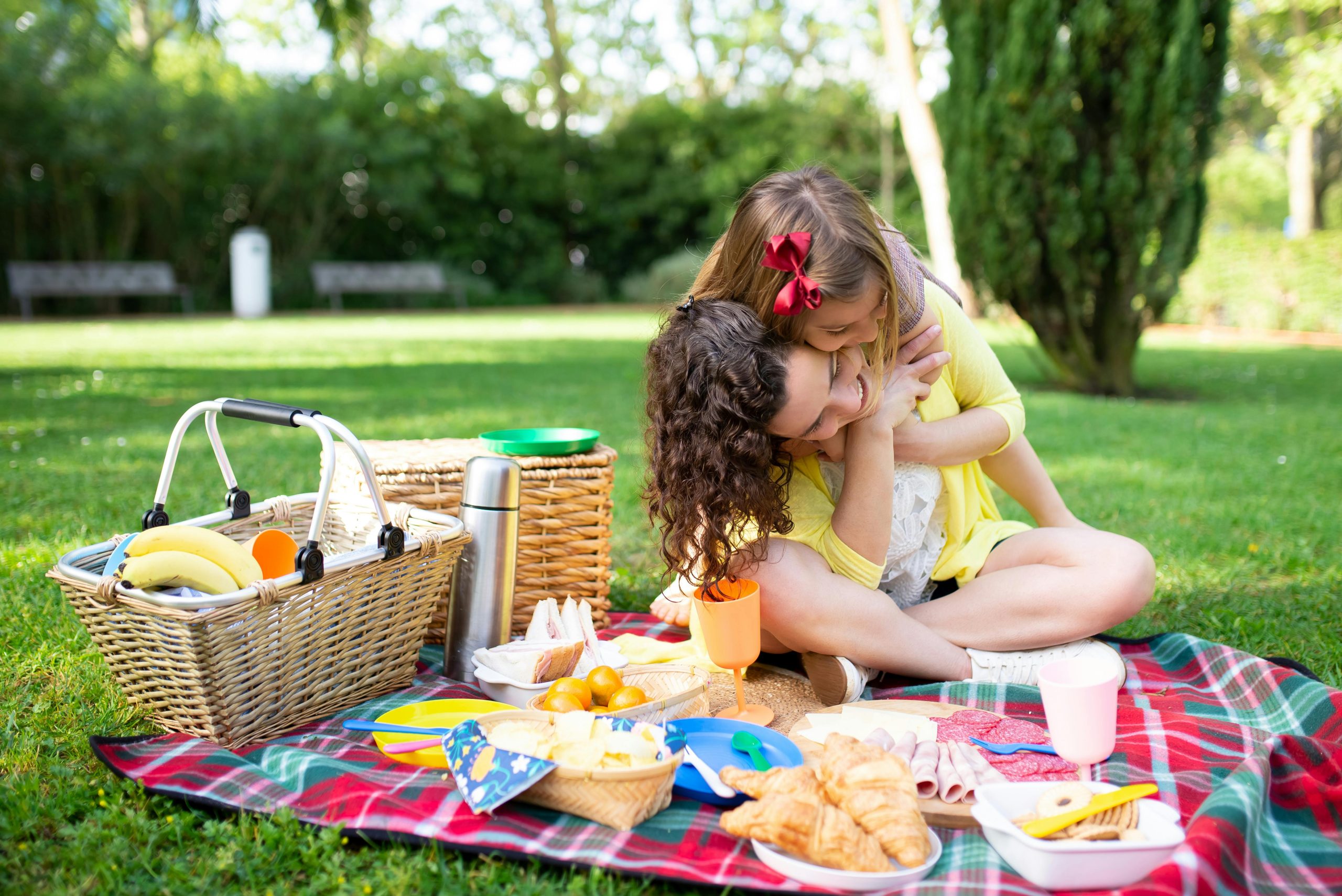 Mum and daughter on picnic blanket