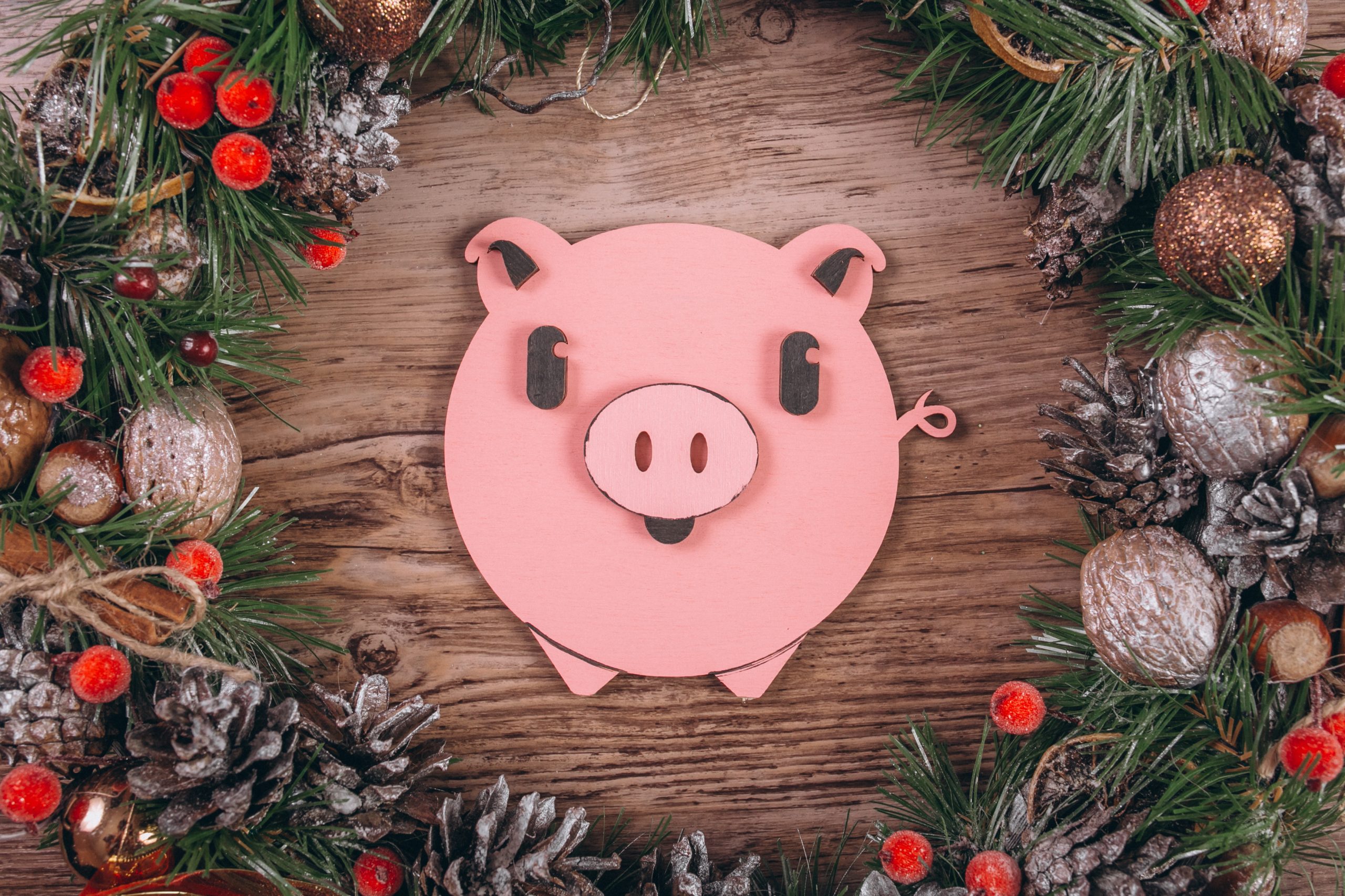 Piggy bank, Christmas flat laying on wooden background